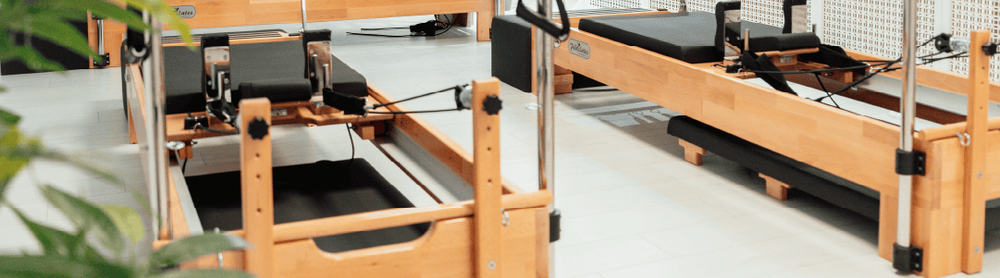 Modern looking Pilates space with working beds  